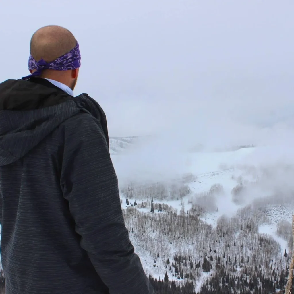 A person stepping onto a visible path in a foggy landscape, symbolizing clarity and direction in personal growth.