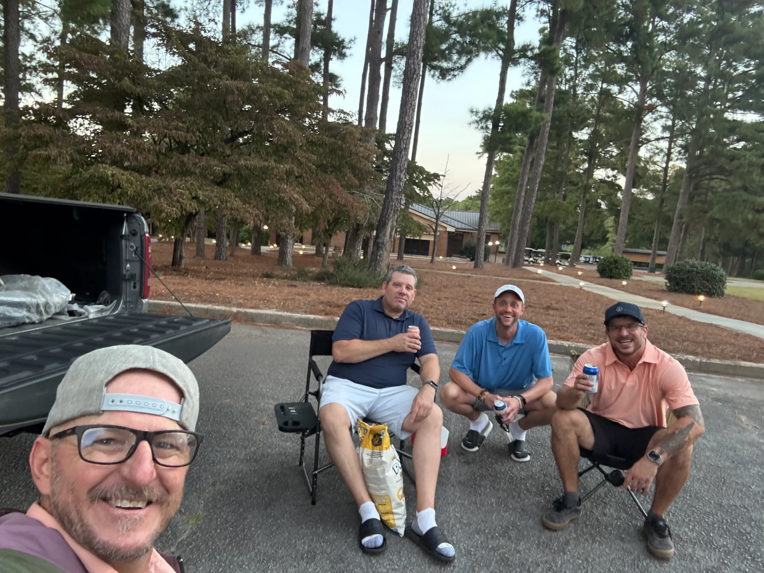 Founder’s story community—men stacking hands before a group round, brotherhood over bravado